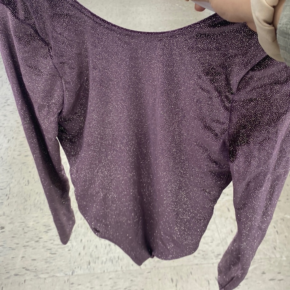 PURPLE VS GLITTER BODY SUIT. Never worn. Glitter does not come off